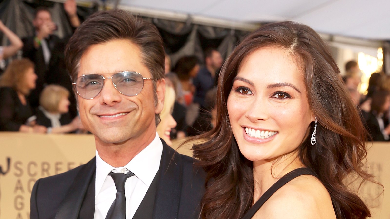 John Stamos and Caitlin McHugh attend the 24th Annual Screen Actors Guild Awards at The Shrine Auditorium in Los Angeles, California.