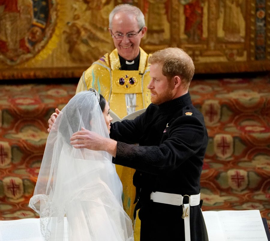 Prince Harry removes her veil.