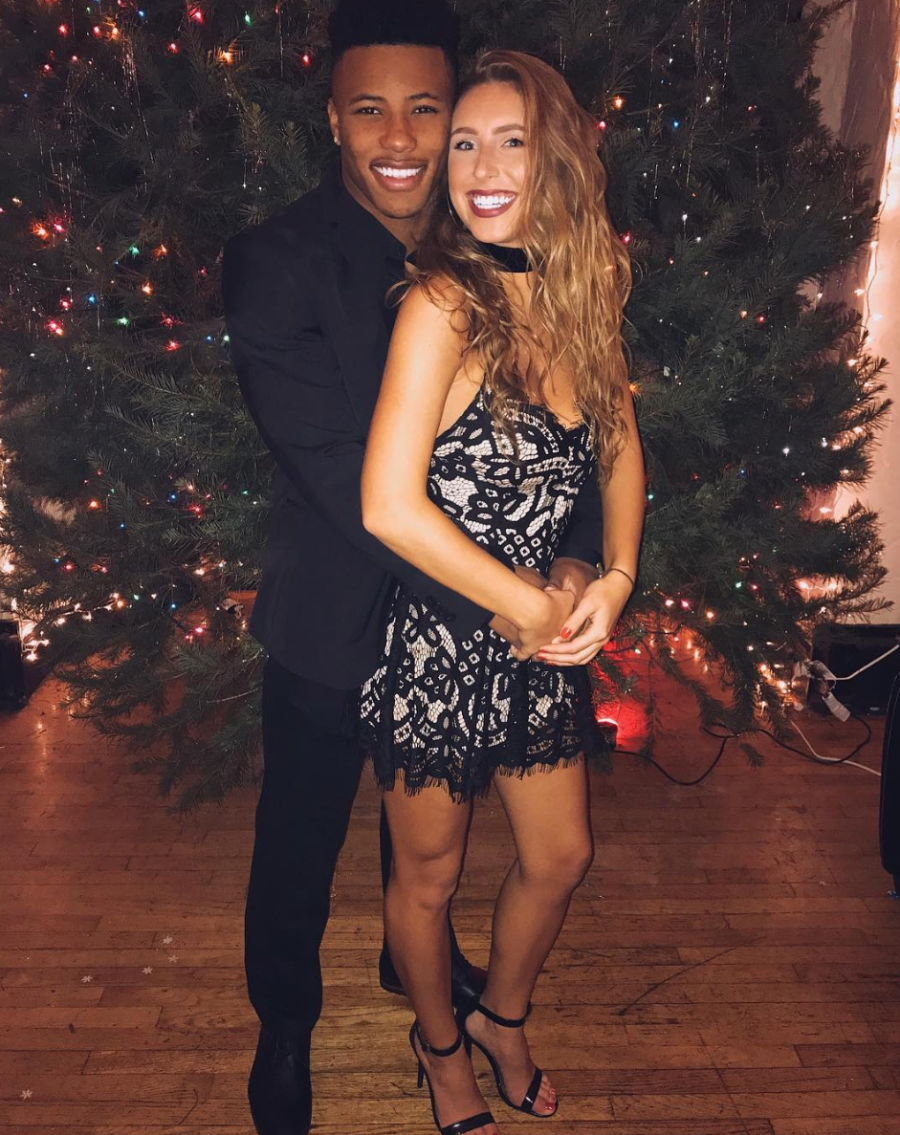 Saquon Barkley and Anna Congdon standing by tree