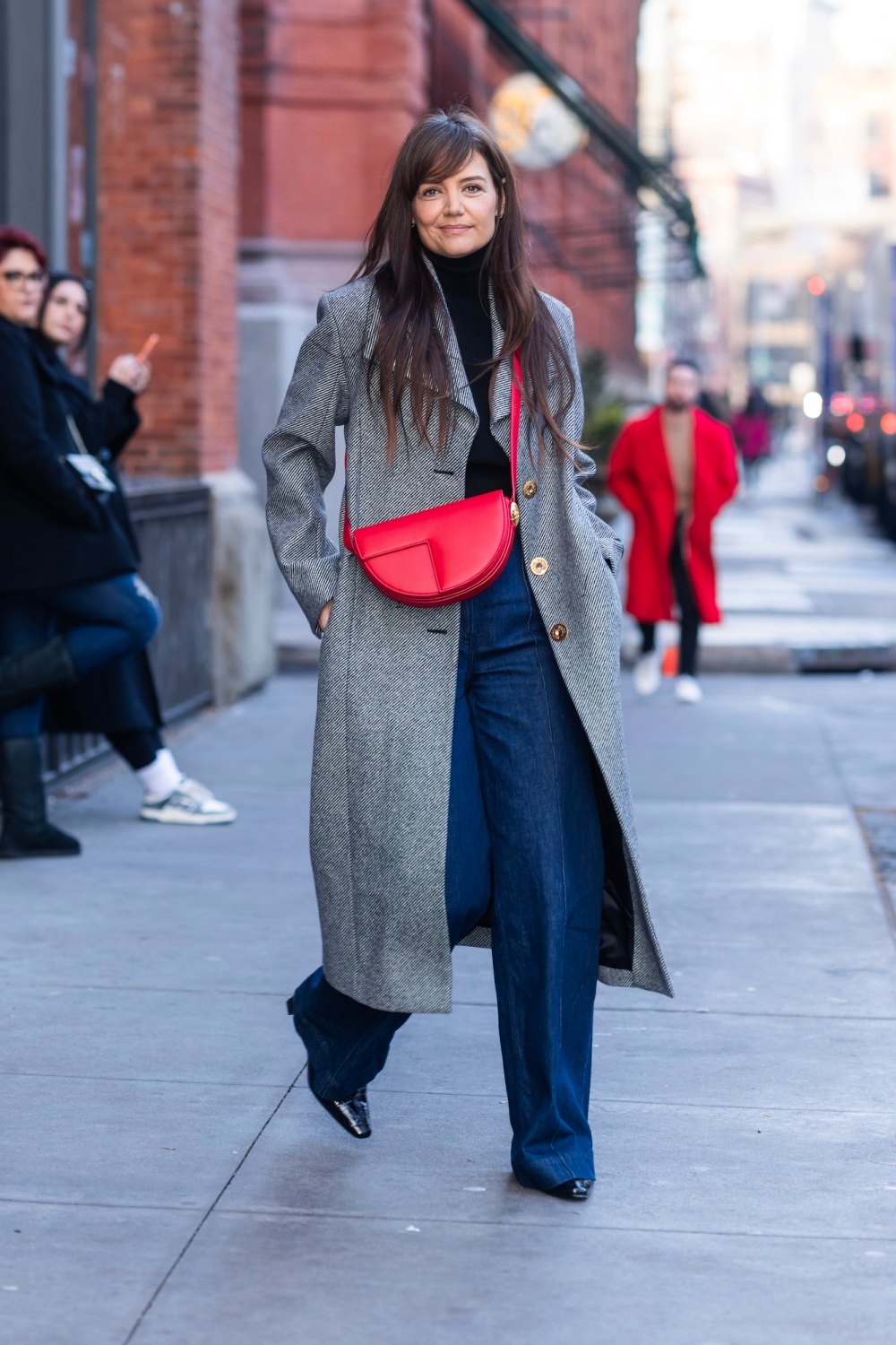 Katie Holmes Adds a Pop of Festive Red to a Neutral Winter Outfit