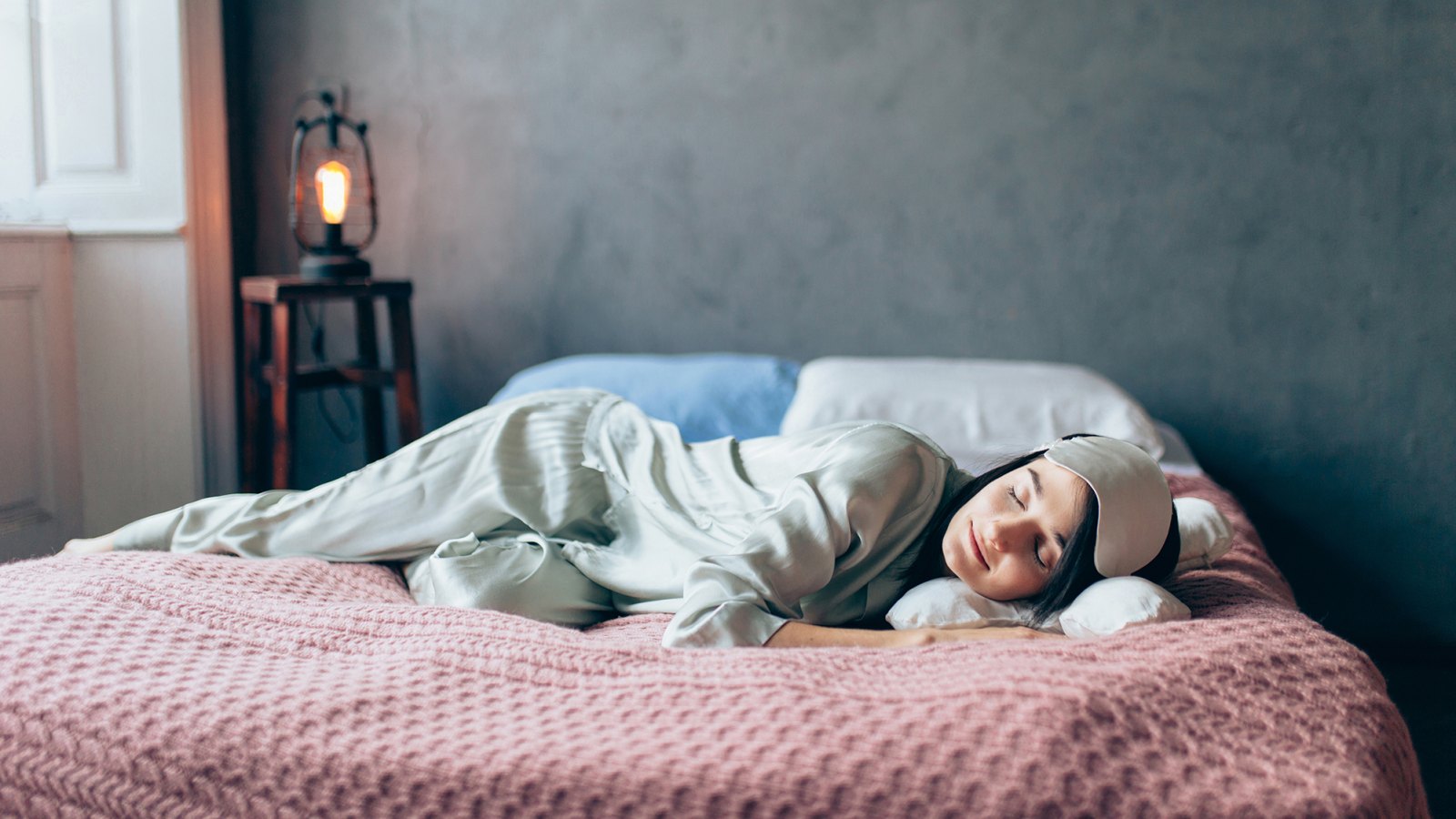 Portrait of woman resting in cozy bedroom.