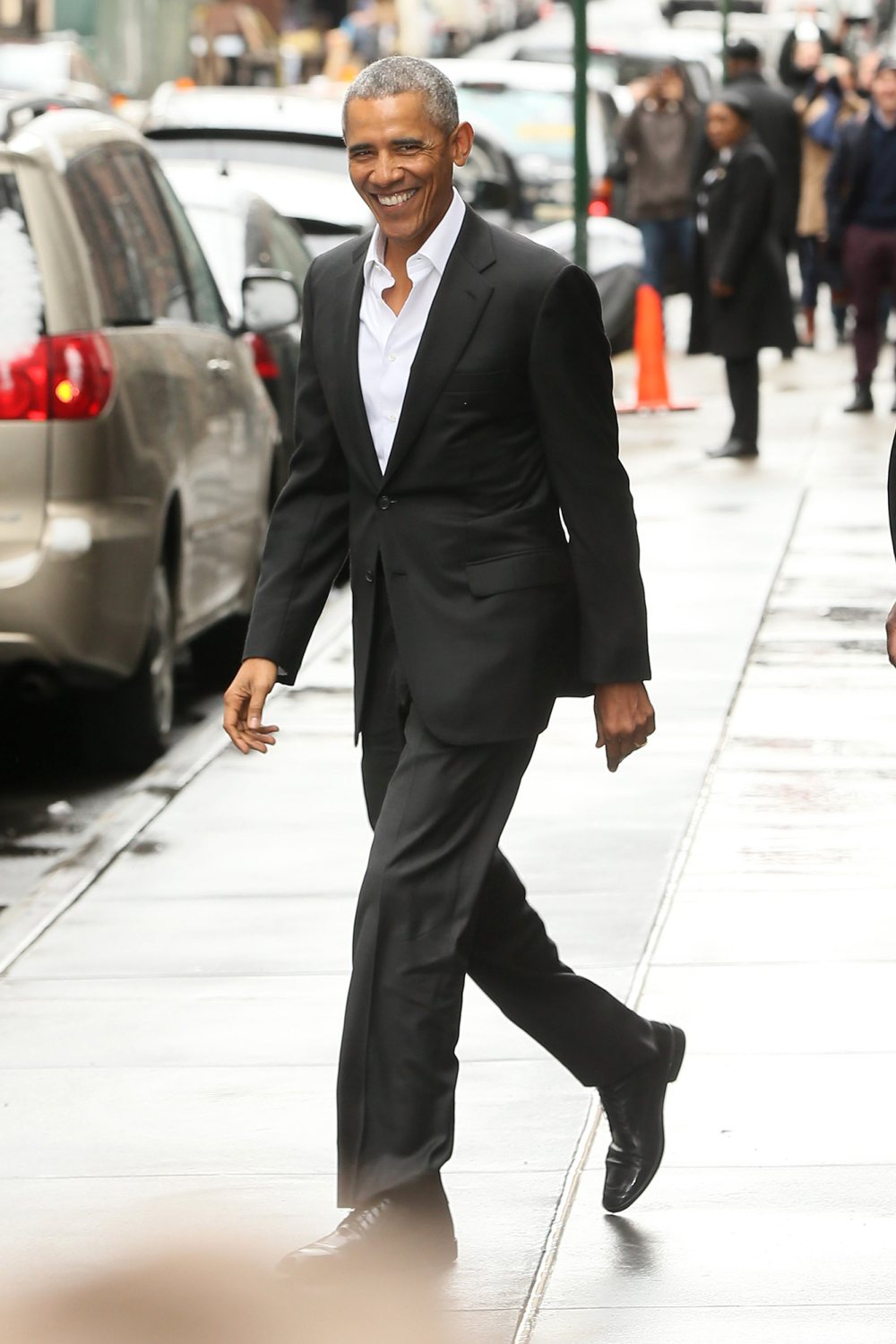 Barack Obama waves to the cameras as he and wife Michelle Obama leave Upland Restaurant where they had a power lunch with musician, Bono.