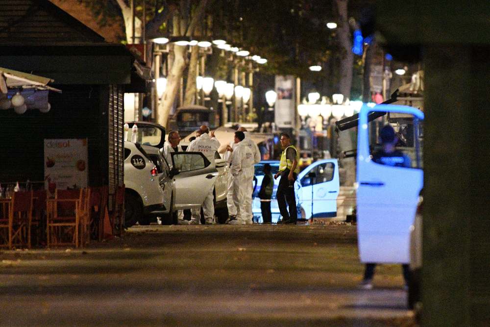 A damaged van, believed to be the one used in the attack, is surrounded by forensics officers in the Las Ramblas area on August 17, 2017 in Barcelona, Spain.