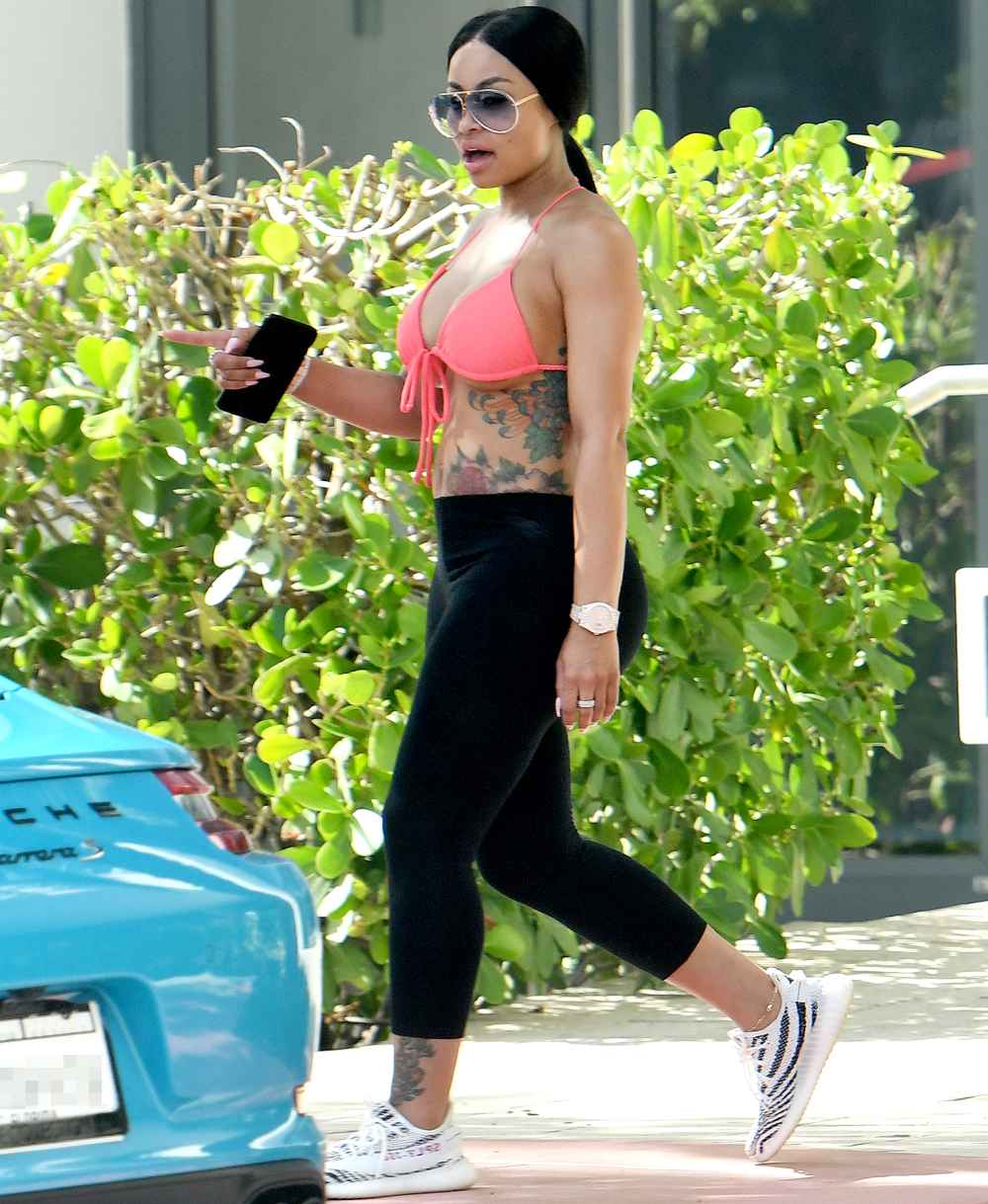 Blac Chyna shows off her post-baby body in a bright pink bikini top as she relaxes with friends by the pool in Miami. INSTARimages.com