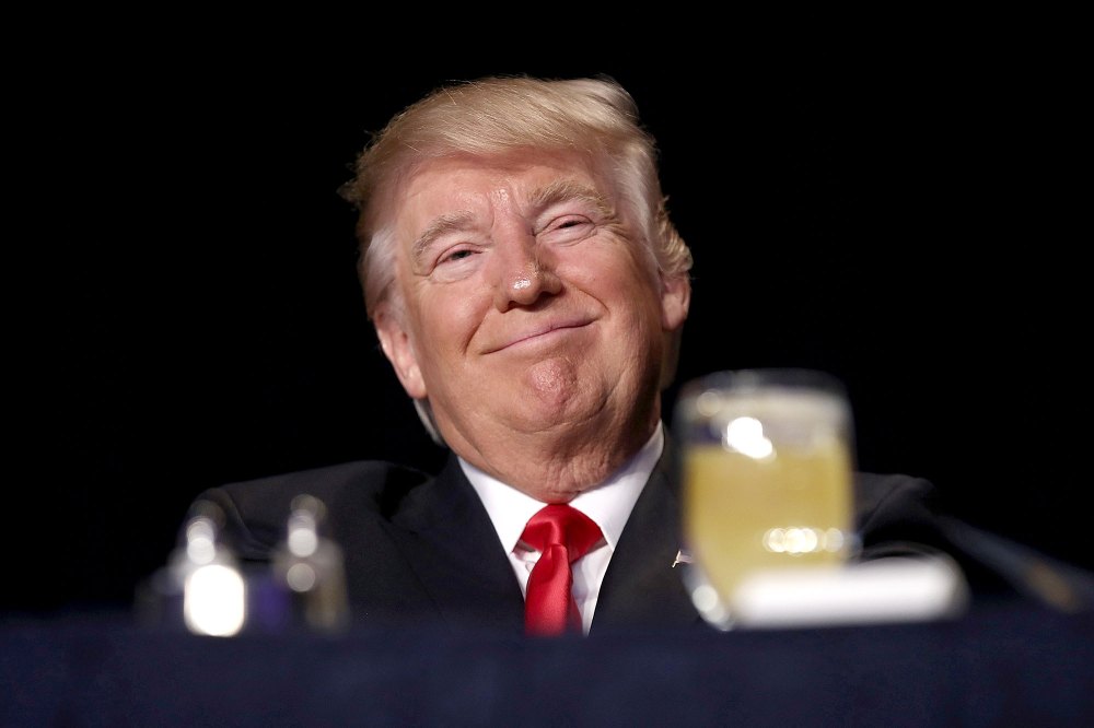 U.S. President Donald Trump listens as television producer Mark Burnett introduces him at the National Prayer Breakfast February 2, 2017 in Washington, DC.