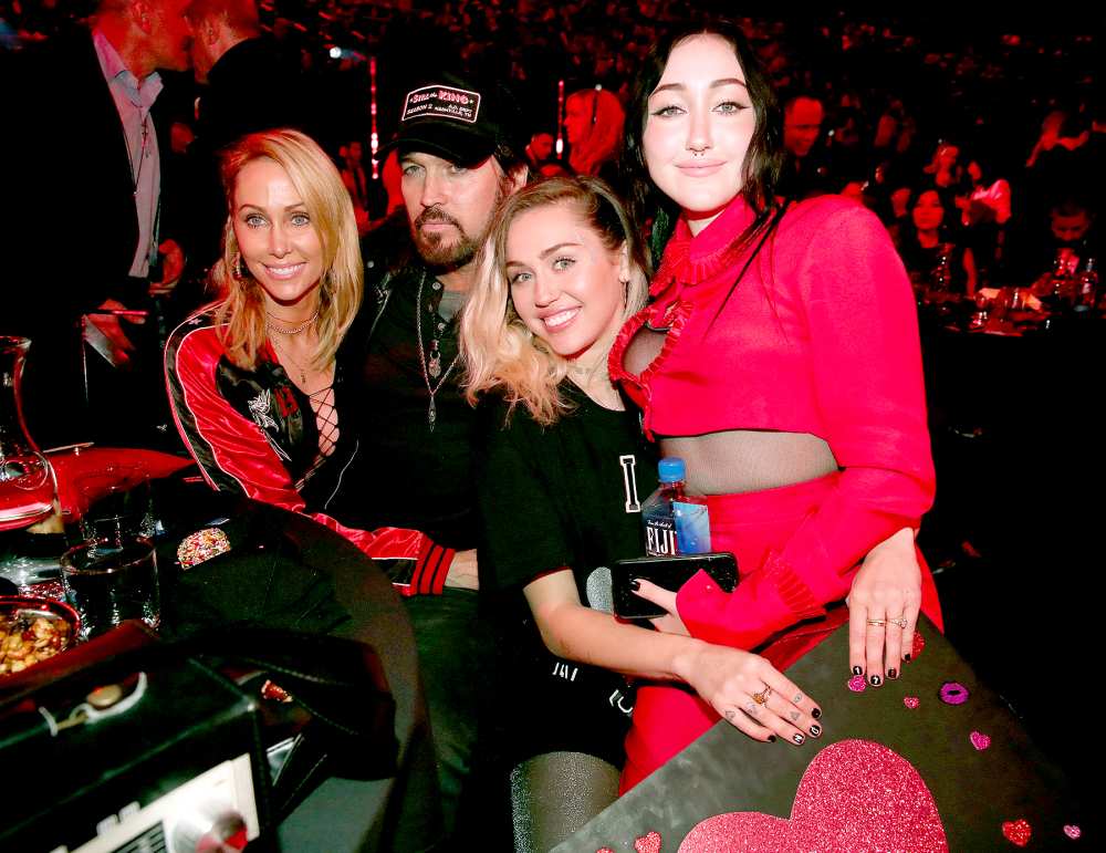 Tish Cyrus, Billy Ray Cyrus, Miley Cyrus, and Noah Cyrus pose with a sign reading 'I heart Noah Cyrus' during the 2017 iHeartRadio Music Awards which broadcast live on Turner's TBS, TNT, and truTV at The Forum on March 5, 2017 in Inglewood, California.