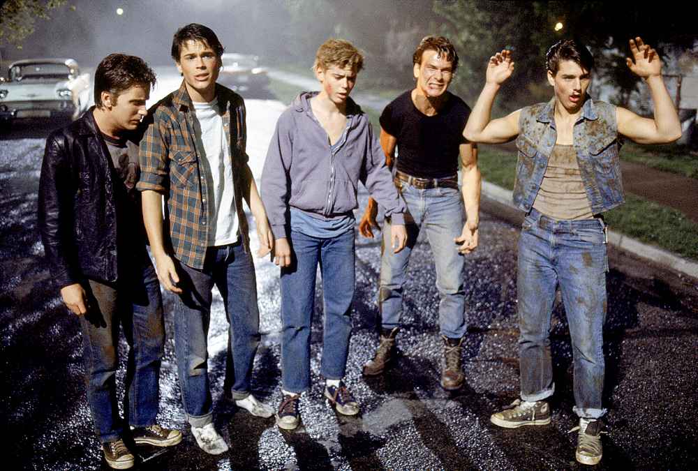 Emilio Estevez, Rob Lowe, Thomas C. Howell, Patrick Swayze, and Tom Cruise on the set of The Outsiders.